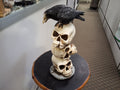 Three Stack Skulls With a Raven On Top