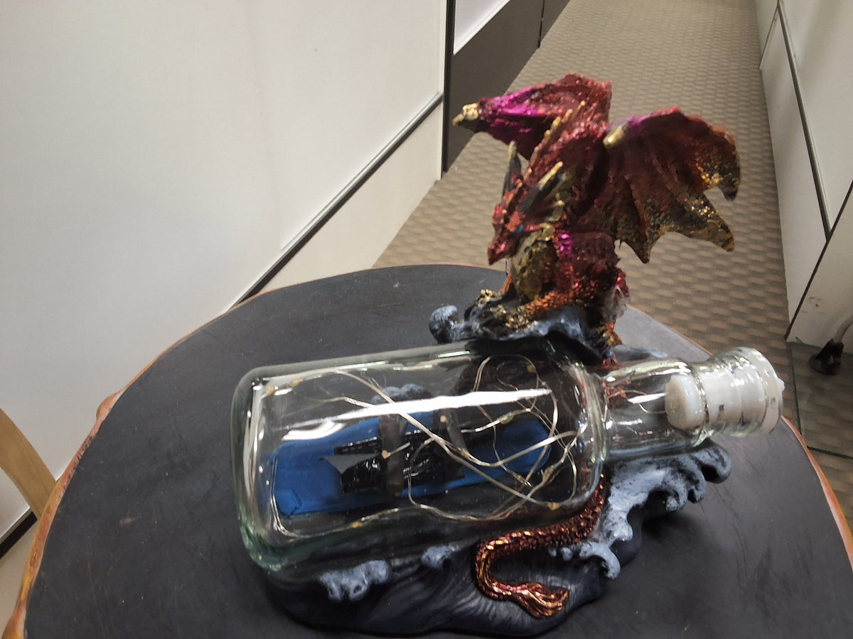 Red Dragon Overlooking A Light-up Bottle