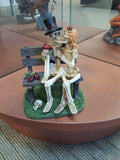 Kissing skeletons on a bench statue