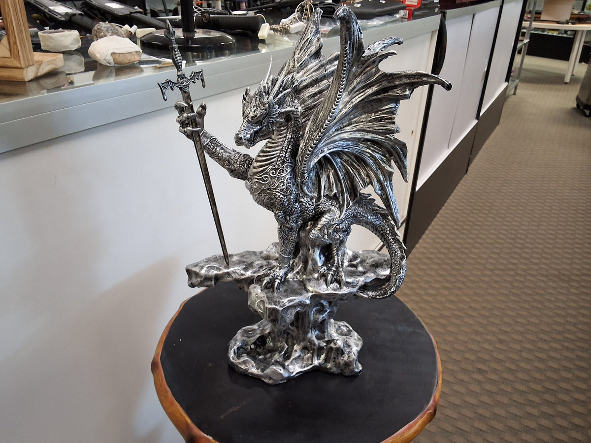 Silver Dragon On Top Of Stone Perch With Sword
