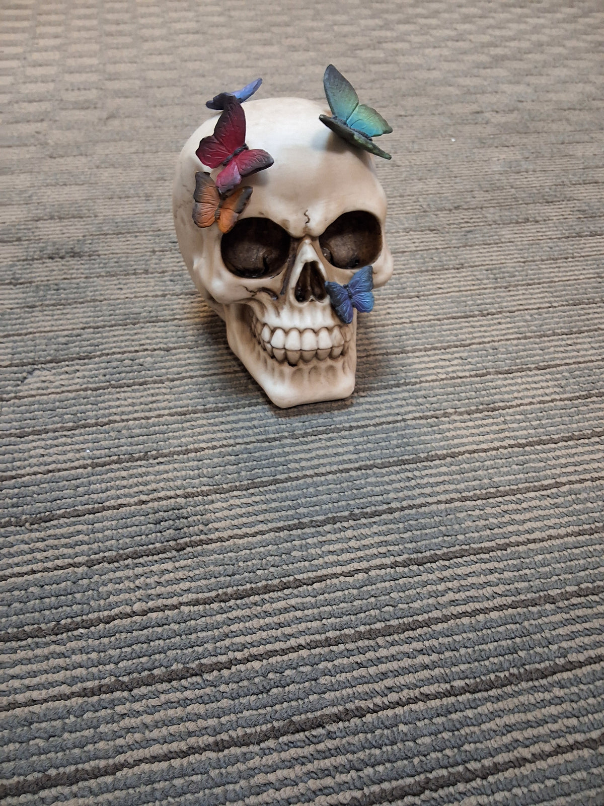SKULL WITH BUTTERFLIES STATUE