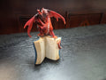 Red Dragon On Top Of A Book
