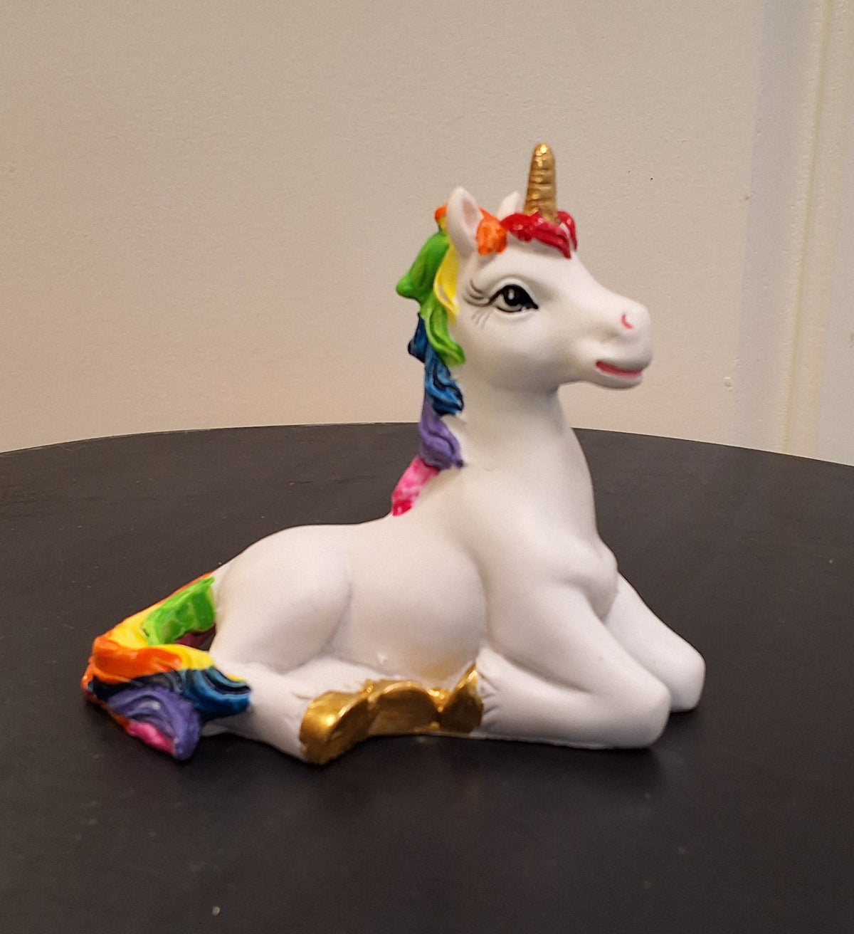 Rainbow unicorn sitting