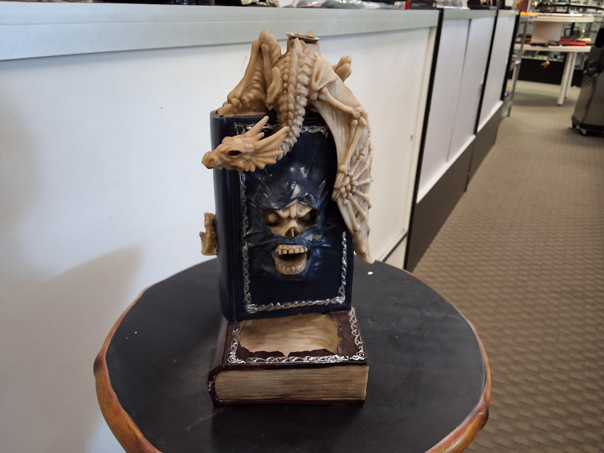 Skeleton Dragon on Top of Book With Skull