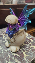 Purple baby dragon in egg